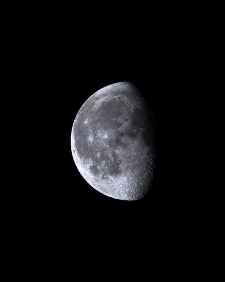 A waning gibbous Moon against black: the lit left side shows smooth grey seas, and craters stand out in sharp relief along the shadow line on the right.